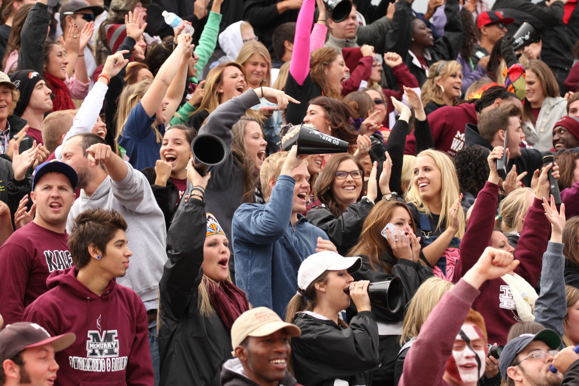 Group of students cheering at football game
