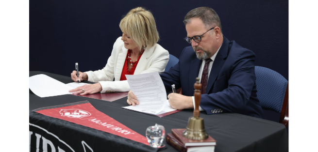 Dr. Murray and Dr. John Kuhn signing