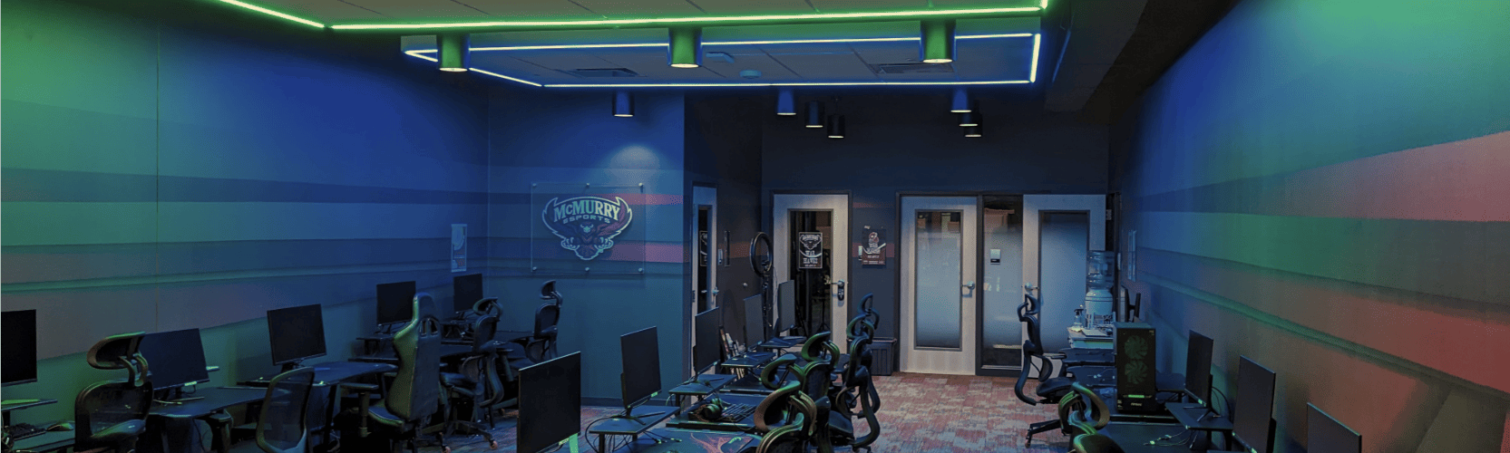 McMurry Esports Lab with rows of gaming computers and colorful overhead lighting.
