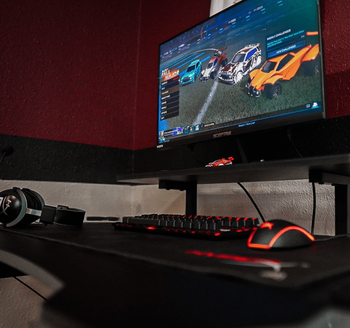 Gaming workstation in the McMurry Esports Lab with a monitor, keyboard, mouse, and headset.
